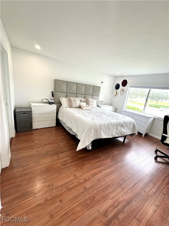 4079 Northlight Drive, Unit 1802 Naples, FL 34112 - Photo 19 of 29 a bedroom with a bed and a chair