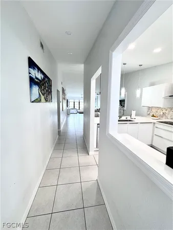a large white kitchen with a sink and cabinets