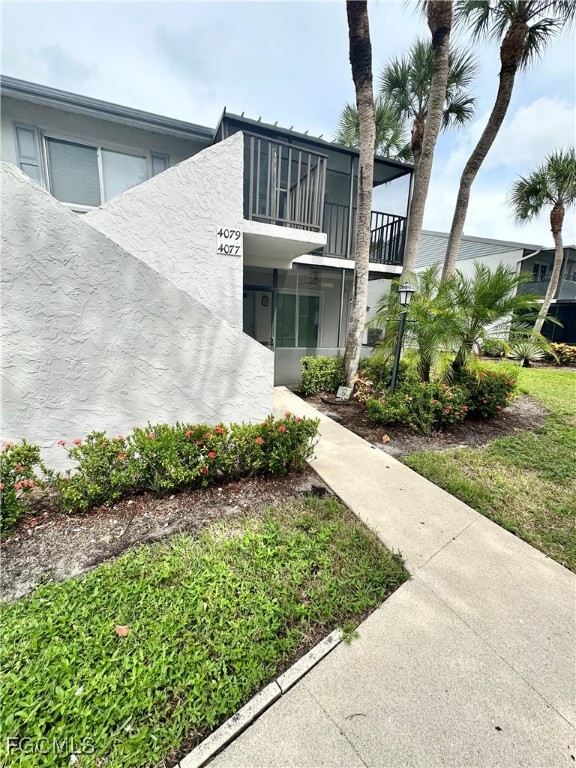 4079 Northlight Drive, Unit 1802 Naples, FL 34112 - Photo 2 of 29 a front view of a house with a garden
