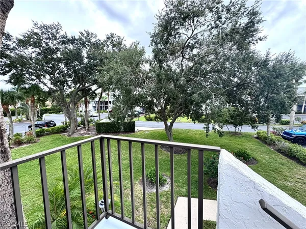 a view of a deck with a trees in the background