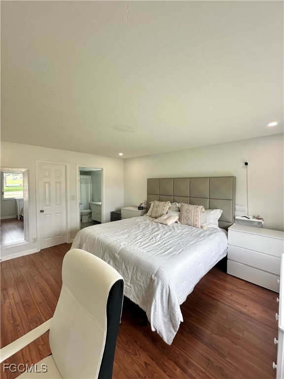 4079 Northlight Drive, Unit 1802 Naples, FL 34112 - Photo 21 of 29 a bedroom with a bed and wooden floor