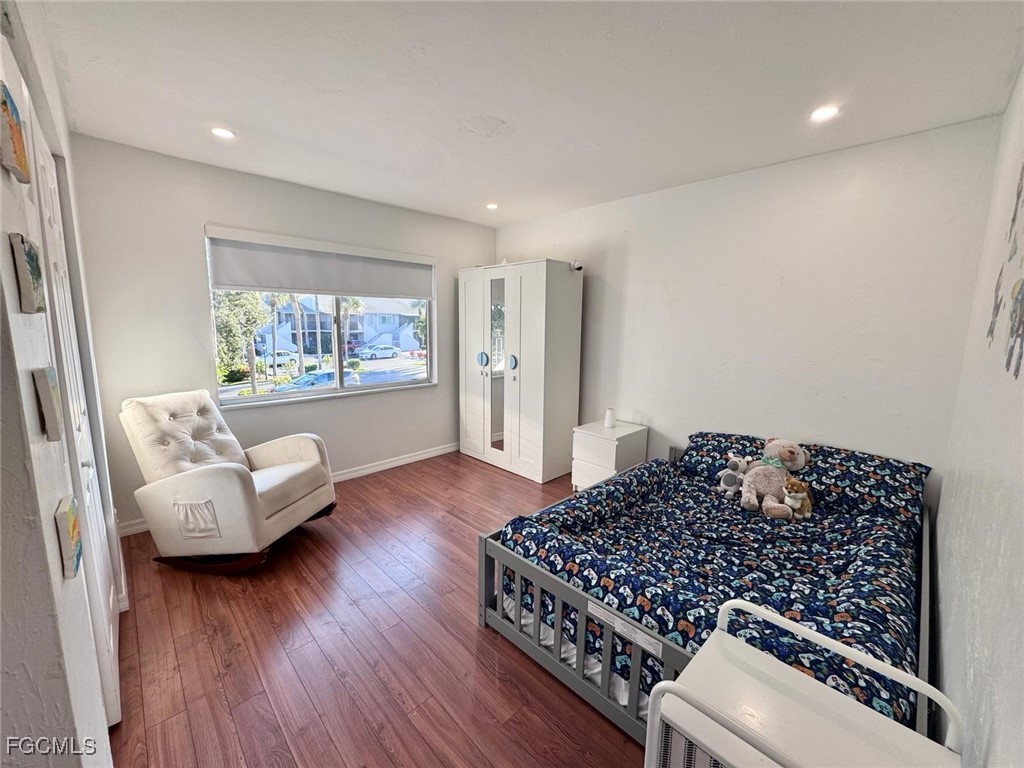 4079 Northlight Drive, Unit 1802 Naples, FL 34112 - Photo 25 of 29 a living room with furniture and a wooden floor