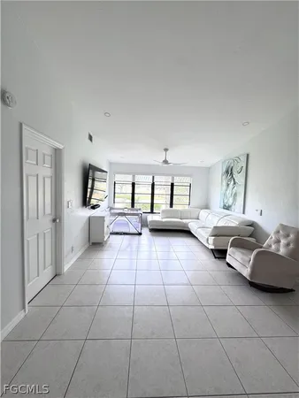 a living room with furniture and white walls