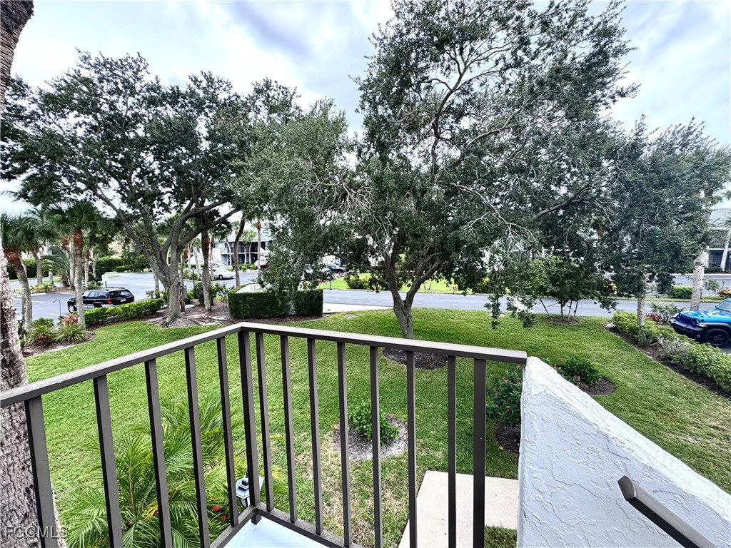 4079 Northlight Drive, Unit 1802 Naples, FL 34112 - Photo 26 of 29 a view of a deck with a trees in the background
