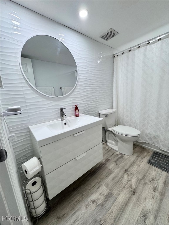 4079 Northlight Drive, Unit 1802 Naples, FL 34112 - Photo 27 of 29 a bathroom with a sink mirror and toilet