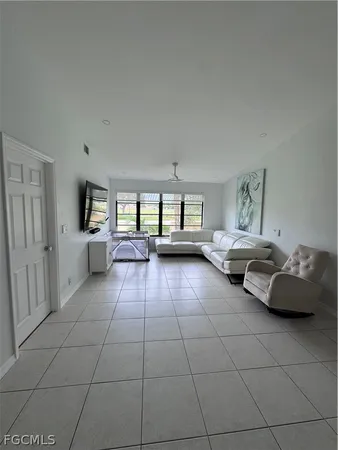 a living room with furniture and large window