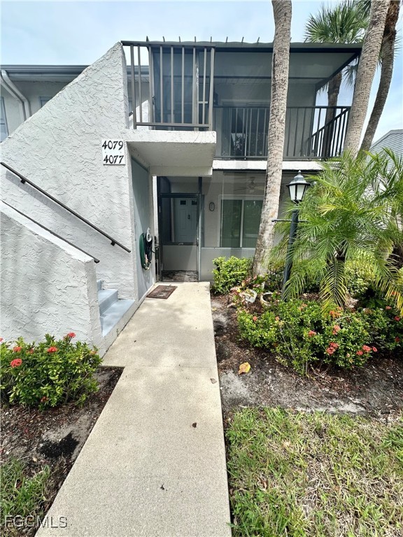 4079 Northlight Drive, Unit 1802 Naples, FL 34112 - Photo 3 of 29 a view of a white house with large windows and plants