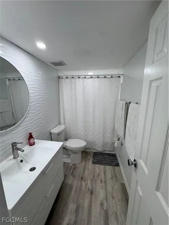 a bathroom with a sink a toilet a shower and a bathtub