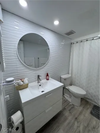 a bathroom with a sink toilet and shower