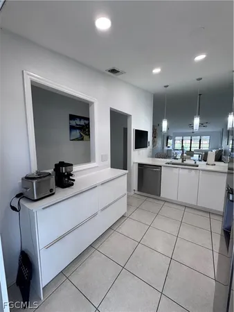 a kitchen with stainless steel appliances kitchen island granite countertop a stove and a refrigerator