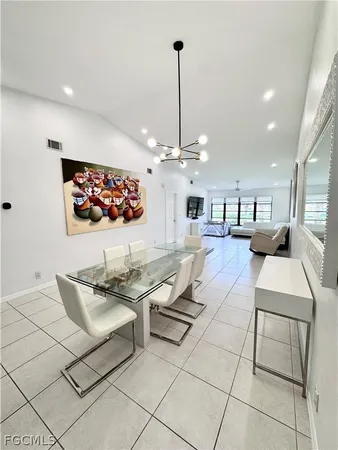 a living room with furniture a table and chairs