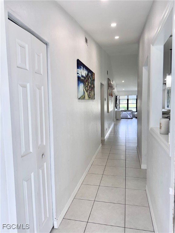 4079 Northlight Drive, Unit 1802 Naples, FL 34112 - Photo 5 of 29 a view of a hallway with wooden floor and a living room