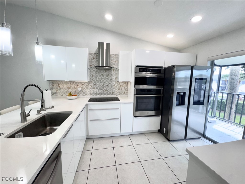 4079 Northlight Drive, Unit 1802 Naples, FL 34112 - Photo 8 of 29 a kitchen with stainless steel appliances a refrigerator sink and cabinets