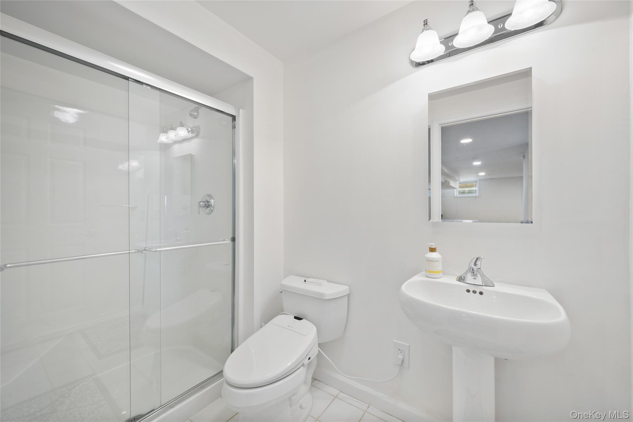 26 Bellefair Road Rye Brook, NY 10573 - Photo 16 of 25 a bathroom with a sink toilet and shower