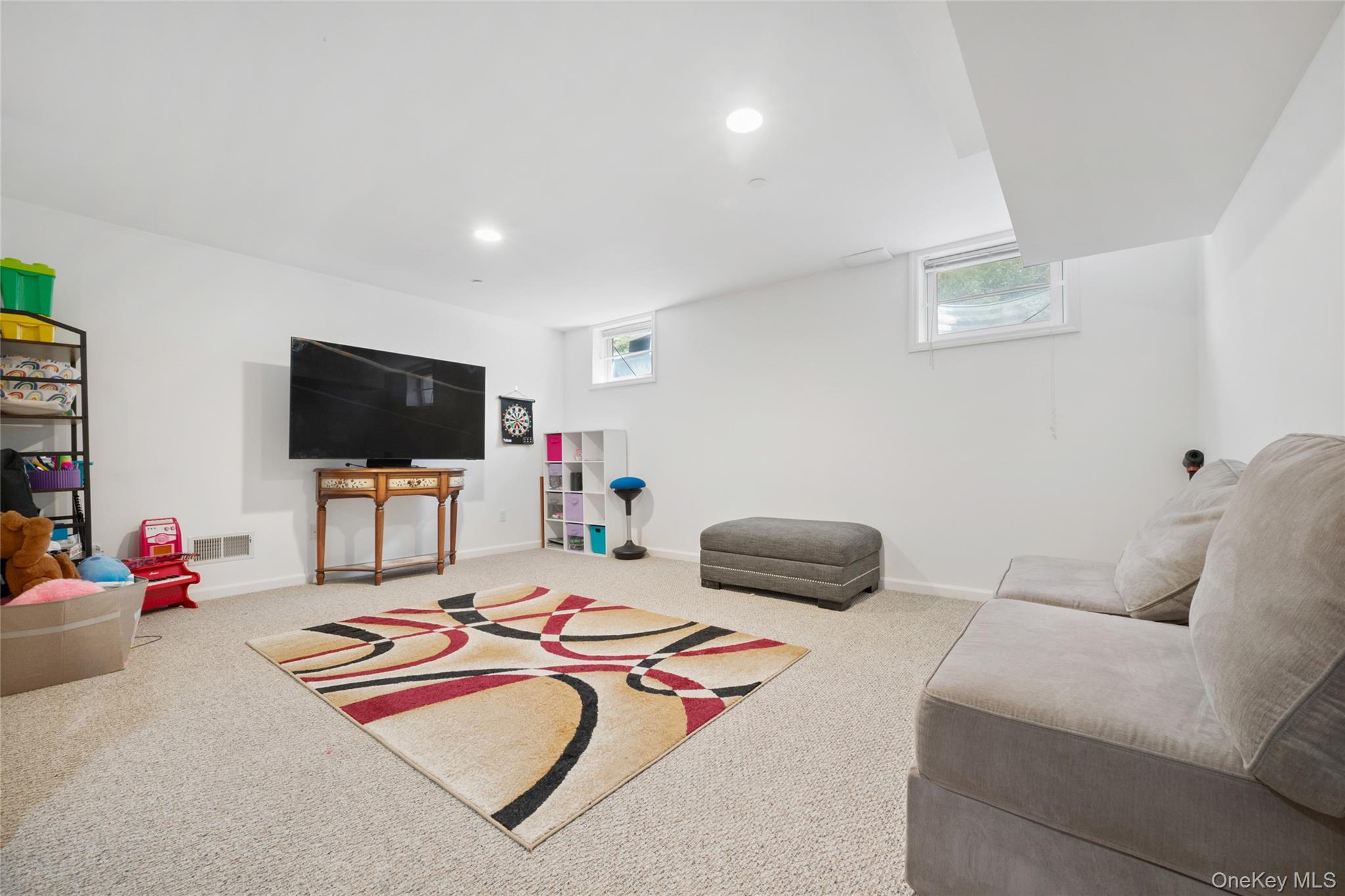26 Bellefair Road Rye Brook, NY 10573 - Photo 18 of 25 a bedroom with furniture and a flat screen tv