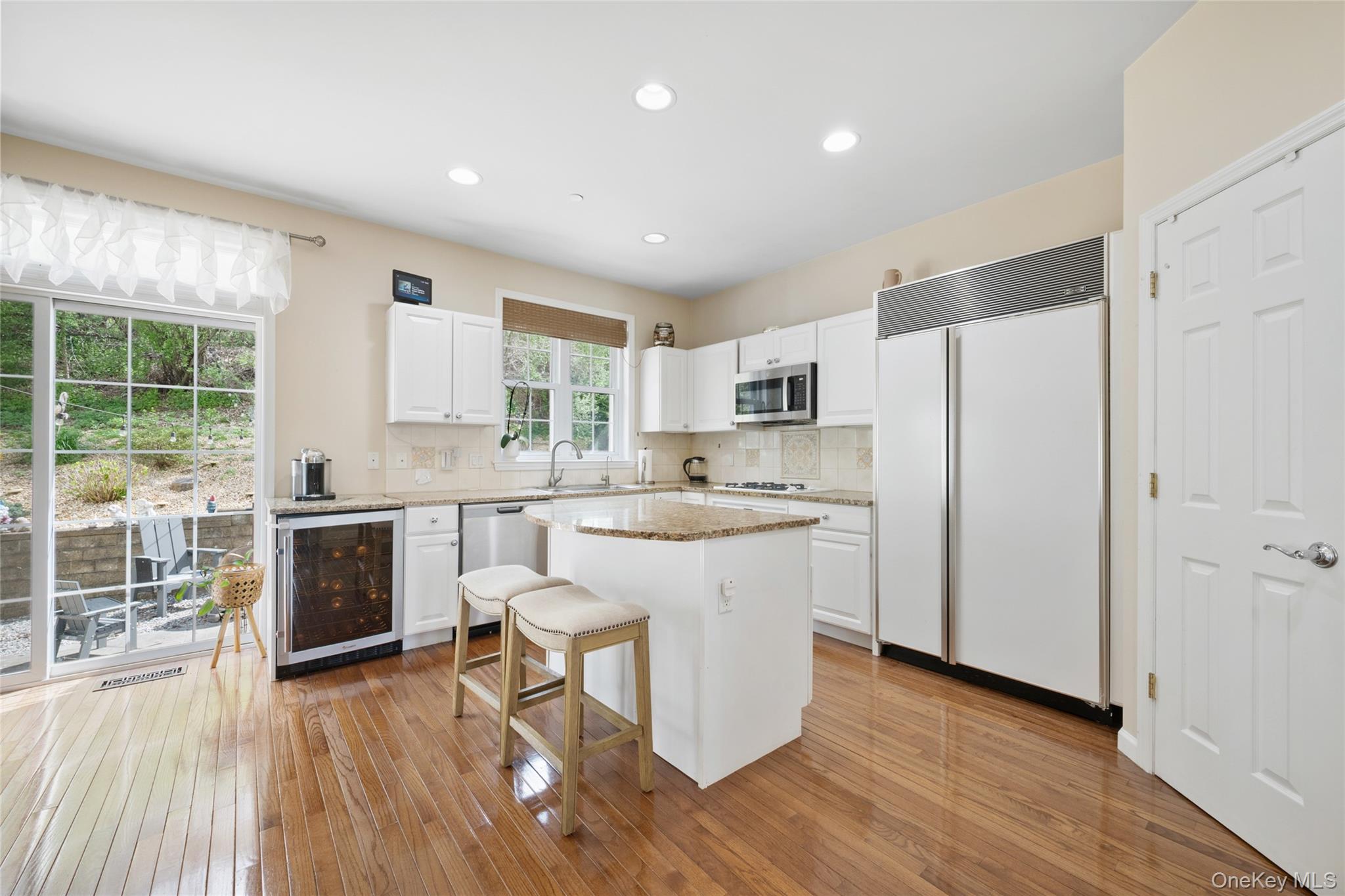 26 Bellefair Road Rye Brook, NY 10573 - Photo 6 of 25 a kitchen with stainless steel appliances a refrigerator a stove top oven and a wooden floors