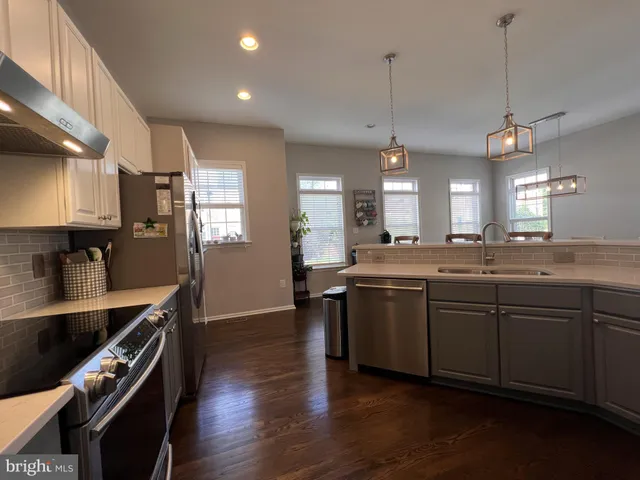 a kitchen with granite countertop stainless steel appliances and wooden cabinets