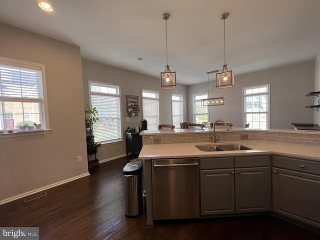 a living room with furniture large windows with wooden floor