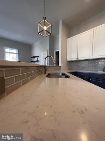 a view of a dining room with furniture large windows and wooden floor