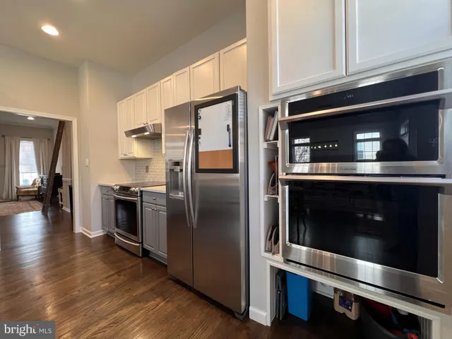 a bedroom with a bed and a flat tv screen on dresser