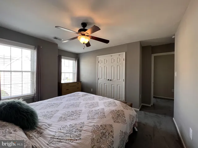 a view of a brick house with a large tree
