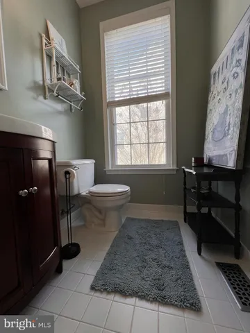 a dining room with furniture a chandelier and wooden floor