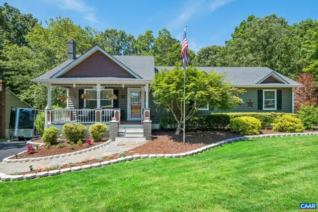 a front view of a house with a yard and porch