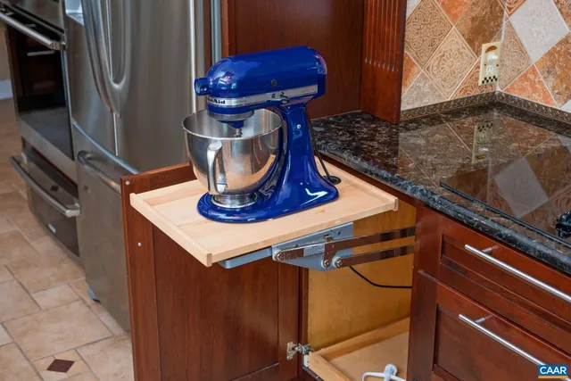 a bedroom with a bed chandelier and a window