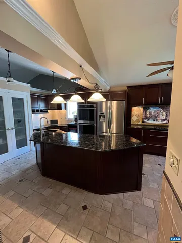 a bathroom with a granite countertop sink a mirror and a shower
