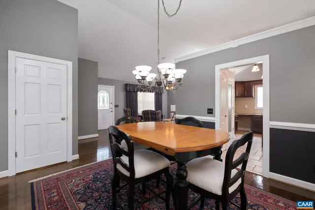 a bed sitting in a spacious bedroom next to a window