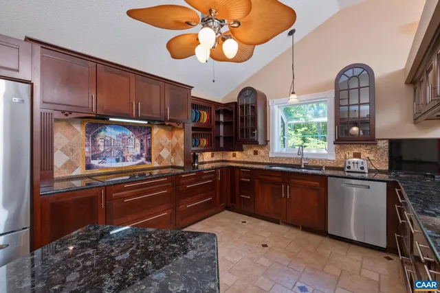 a kitchen with a dining table chairs and a fireplace