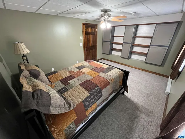 a front view of a house with a yard and green space