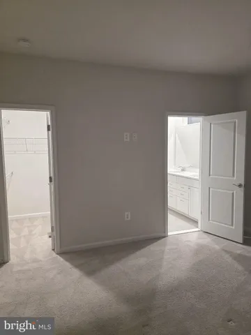 a view of an empty room and a window