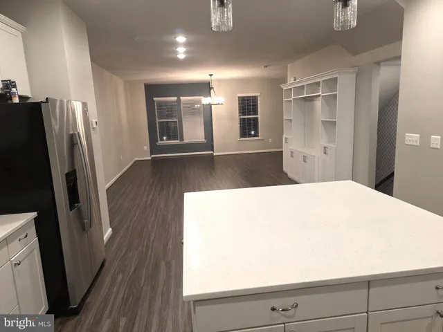 a kitchen with stainless steel appliances a refrigerator and a stove