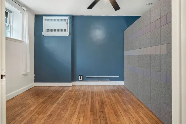 a view of a room with wooden floor and cabinet