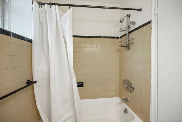 a bathroom with a shower and a tub