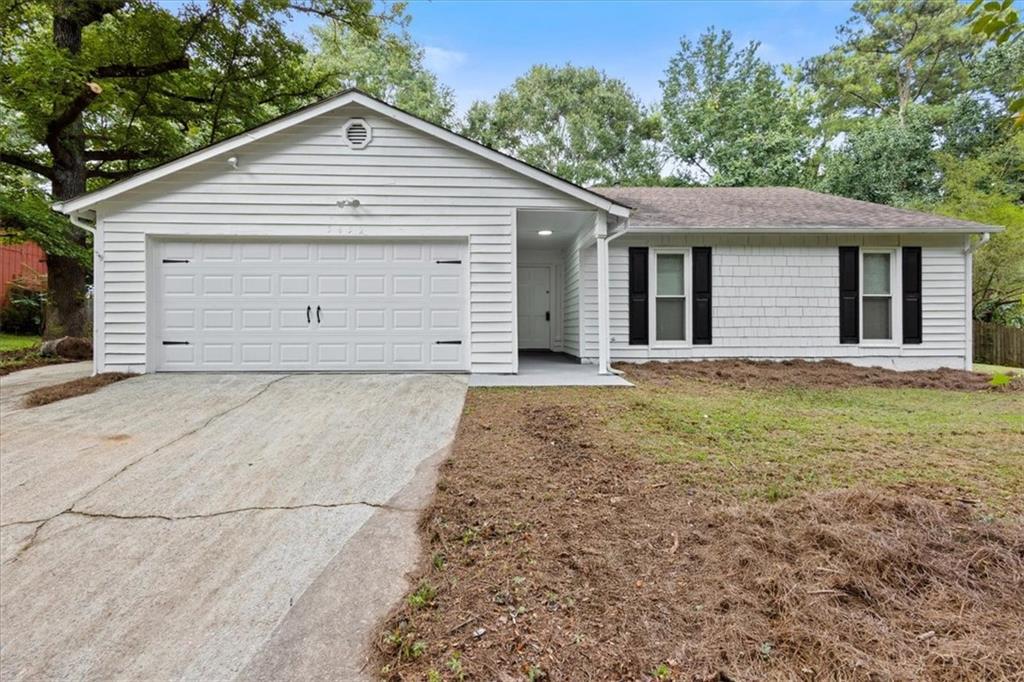 a view of a house with a yard and garage