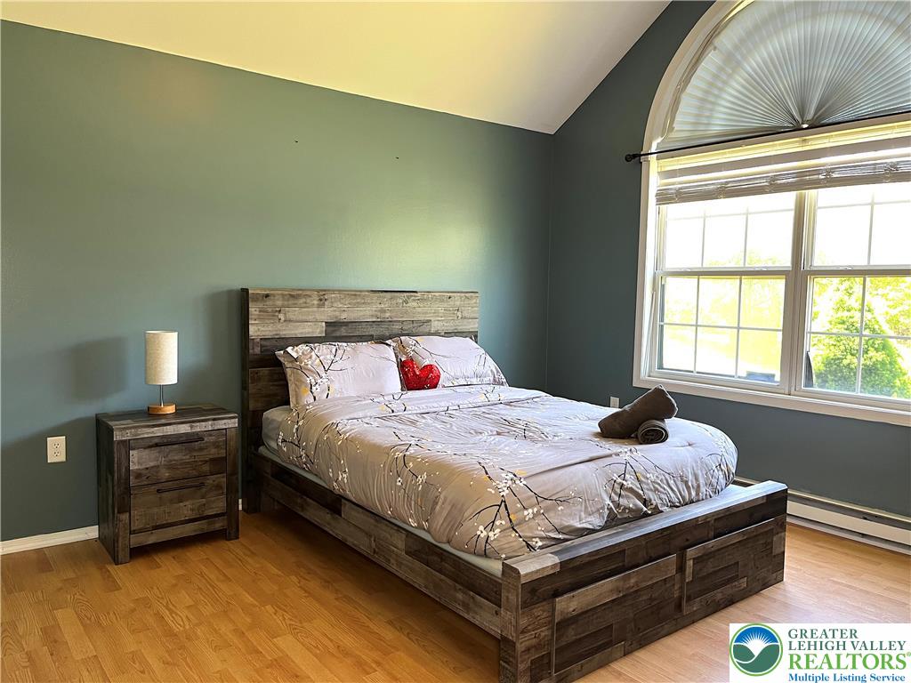 1646 Clover Road Long Pond, PA 18334 - Photo 8 of 24 Vaulted ceilings and warm hardwood floors define this inviting retreat with a large arched window.