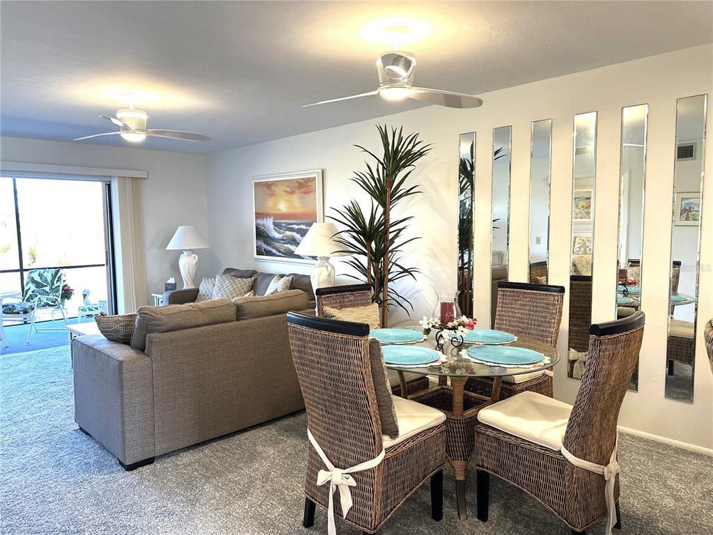 6800 Placida Road, Unit 163 Englewood, FL 34224 - Photo 12 of 24 a living room with furniture and a large window