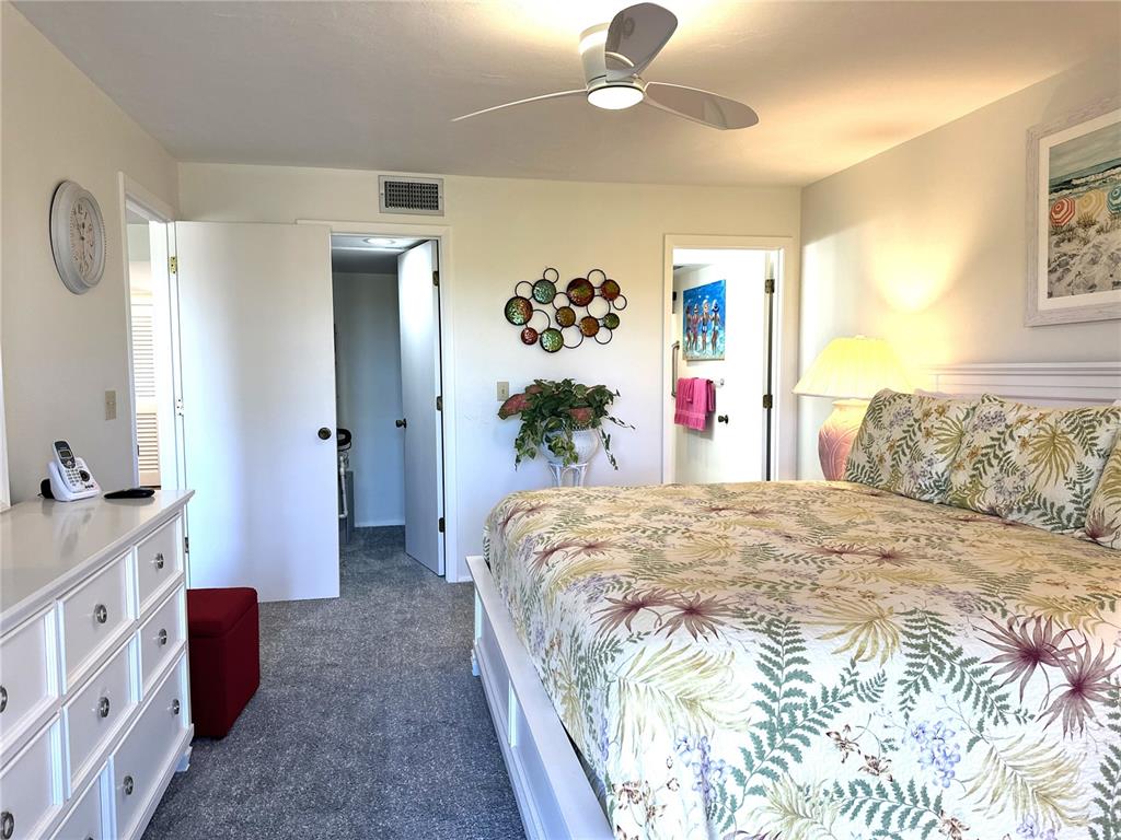 6800 Placida Road, Unit 163 Englewood, FL 34224 - Photo 17 of 24 a spacious bedroom with a bed and dresser with mirror