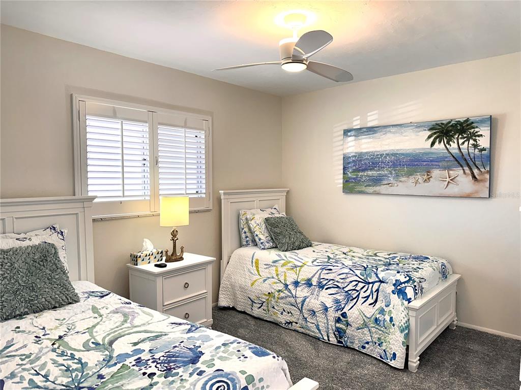 6800 Placida Road, Unit 163 Englewood, FL 34224 - Photo 19 of 24 a bedroom with a bed and a chandelier
