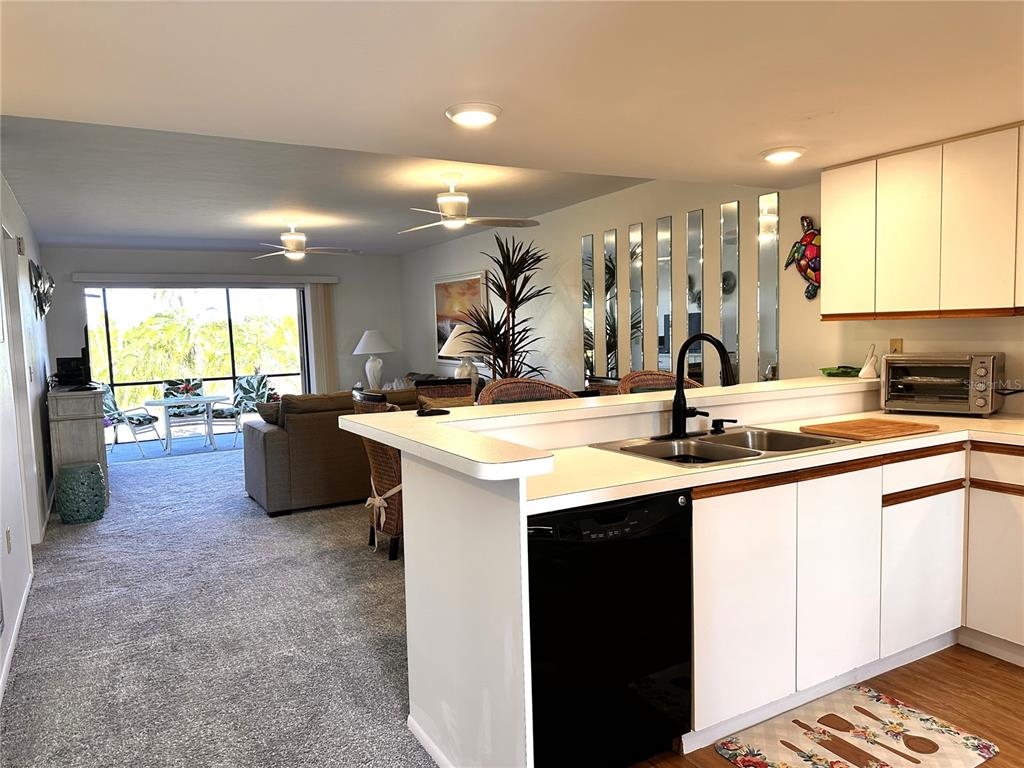 6800 Placida Road, Unit 163 Englewood, FL 34224 - Photo 6 of 24 a kitchen with a sink and large window
