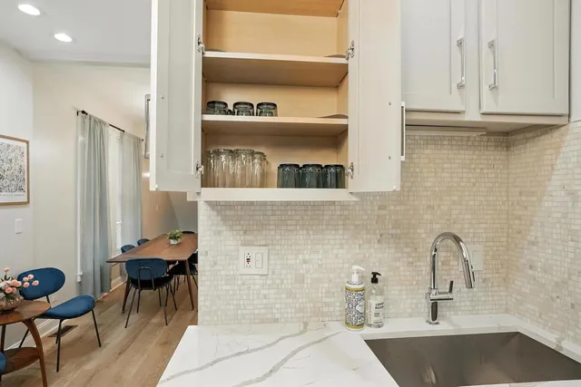 a kitchen with stainless steel appliances a refrigerator and a sink