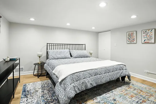 a bathroom with a glass shower door a sink and a shower