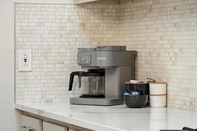 a view of balcony with two chairs and a large window