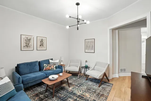 a living room with furniture a rug and a window