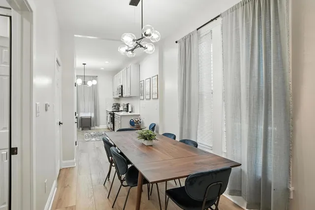 a view of a dining room with furniture and chandelier