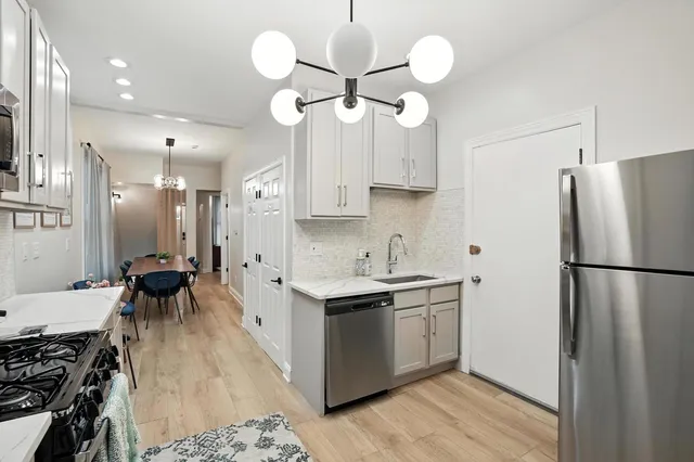 a kitchen with stainless steel appliances a stove center island and cabinets
