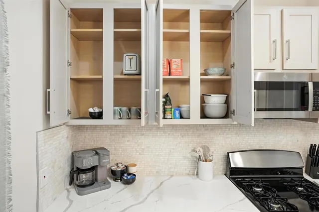 a kitchen with wooden cabinets and a stove top oven