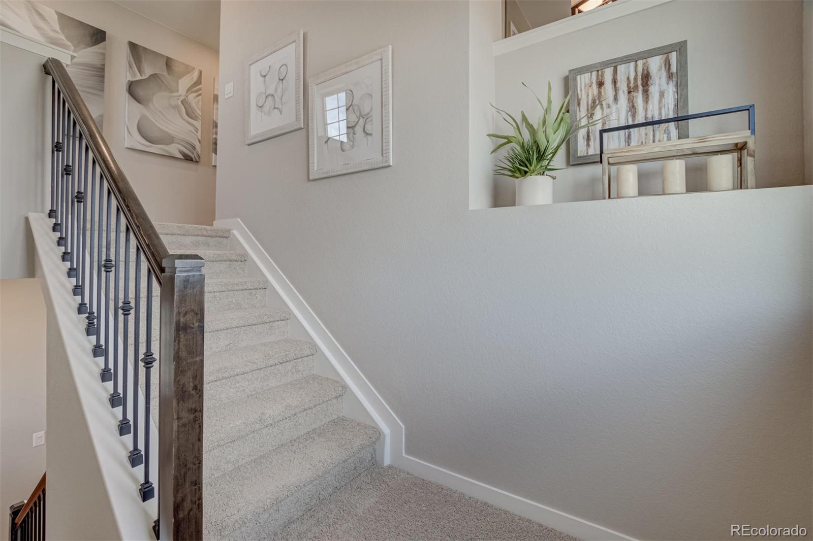 1188 Sugarloaf Road Boulder, CO 80302 - Photo 19 of 35 a view of staircase with wooden floor and lots of potted plants